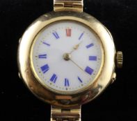 An early 20th century 15ct gold wrist watch, the white circular dial with red and blue Roman