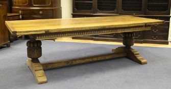A 17th century design oak extending refectory table, on carved and turned baluster legs and