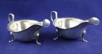 A pair of 1930`s silver sauceboats, with cut rims, on pad feet, Viner`s Ltd, Sheffield, 1936, length