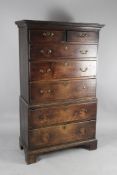 A late 18th century oak tall boy, in two sections, fitted two short and five long graduated drawers,