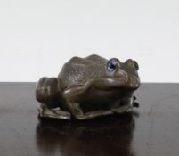 A Japanese weighted bronze figure of a seated frog, Meiji period, with glass inset eyes, 3.25in. -