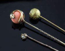 A gold, coral and diamond set stick pin, with serpent terminal, 3.5in, together with two other stick