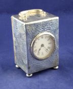 An Edwardian planished silver cased carriage timepiece, of rectangular form, with loop handle and