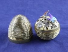 A cased 1970`s textured silver gilt surprise egg, by Stuart Devlin, opening to reveal two