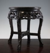 A late 19th century Chinese carved hardwood marble top jardiniere stand, decorated with prunus,