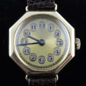 A lady`s 1920`s 15ct gold Rolex wrist watch, with octagonal case and Arabic dial with disc numerals,