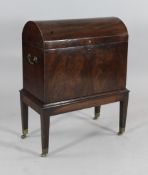 A George III mahogany dome top cellaret on stand, with compartmented interior, on tapered square