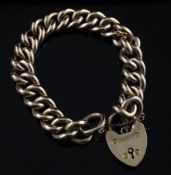 A 9ct gold curblink bracelet, with heart shaped padlock, 26.5 grams.