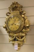 A Swedish giltwood Cartel clock, with printed dial and movement striking on a bell, 21in.