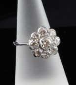 An 18ct white gold nine stone diamond cluster ring, of flower head design, total weight