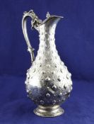 A Victorian silver hot water jug, with military related inscription, of baluster form, embossed with