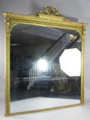 A large early Victorian carved giltwood and gesso overmantel mirror, with an elaborate crest of