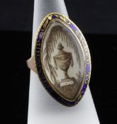 A George III gold and blue enamel navette shaped mourning ring, with inset ivory panel decorated
