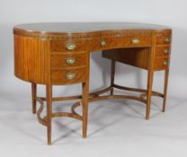 An Edwardian inlaid satinwood kidney shaped writing table , with leather inset top above eight
