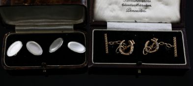 A cased pair of George V 14ct gold and silver cufflinks, modelled as crossed horseshoe and riding