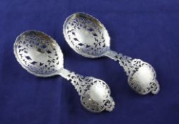 An ornate pair of Victorian silver spoons, with pierced foliate bowls and handles, Holland,