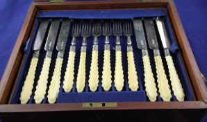 A cased set of twelve pairs of Victorian silver ivory handled dessert eaters, with ribbed handles,
