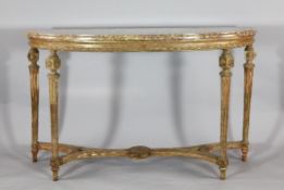 An early 19th century gilt and painted wood and gesso console table, with later marble top on carved