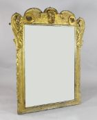 A George II carved giltwood and gesso overmantel mirror, modelled with a central mask, acanthus