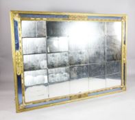 A large 19th century carved giltwood and gesso sectional rectangular mirror, with a blue glass outer