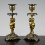 A pair of 19th century gilt brass and cloisonne enamel dwarf candlesticks, modelled with triple