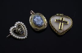 A George III gold, enamel and seed pearl set heart shaped mourning brooch, with panel set with