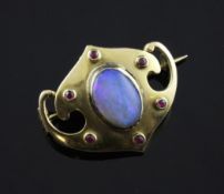 An Edwardian Art Nouveau 15ct gold, white opal and ruby set brooch, by Murrle Bennett, 1in.