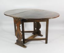 An oak oval gateleg table, 17th century, with profile baluster end supports with stylised carving,