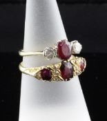 A late Victorian 18ct gold, garnet and diamond ring, with scroll setting, size P, now with pendant