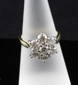 An 18ct gold seven stone diamond cluster ring, size N.