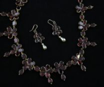 A Victorian gold and garnet set necklace and pair of matching earrings, of flowerhead design, the