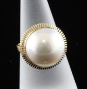 An 18ct gold and mabe pearl dress ring, with milled setting, size M.