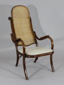 A bentwood armchair, with caned back and upholstered seat