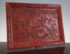 A Chinese cinnabar lacquer tray, 19th century, carved in high relief with sages and attendants