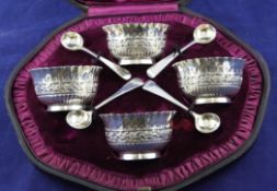 A cased set of four Victorian silver circular salts and matching spoons, with demi fluted