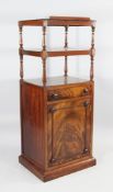 An early Victorian mahogany whatnot, with ratcheted top above a drawer and cupboard door, on