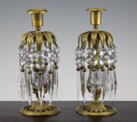 A pair of late 19th century Viennese enamel and brass lustre candlesticks, decorated with scenes