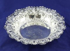 A late Victorian repousse silver circular bowl, decorated with scrolling foliage, Fenton Brothers