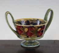 A William Moorcroft `Pomegranate` pattern twin handled pedestal bowl, dated 1913, with a pale