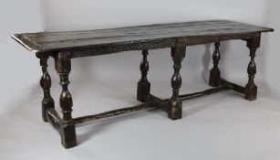 A 17th century oak refectory table, with three plank top on turned legs and block feet, modified,