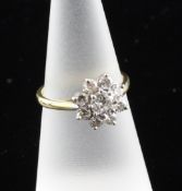 An 18ct gold and platinum nine stone diamond cluster ring, size M.