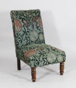 A Victorian chair covered in Morris & Co Elmcote pattern upholstery, woven wool and mohair, designed