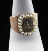 A George III gold memorial ring, with diamond set initial `L` within a seed pearl border