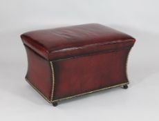 A modern red leather ottoman, with hinged top on fitted castors, 1ft 6in. x 2ft 6in.