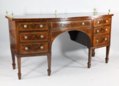 A George III inlaid mahogany bowfront sideboard, with four drawers and a cupboard door, on tapered