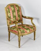 A Louis XVI style carved giltwood and gesso fauteuil, 19th century, with floral French silk
