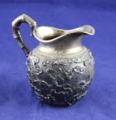 A late 19th/early 20th century Chinese silver cream jug, of baluster form, with applied dragon