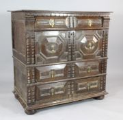 A late 17th century oak split section chest, with four long fielded panel drawers on bun feet, 3ft 4