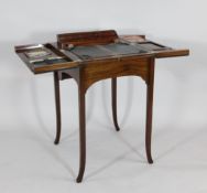 An Edwardian `pop up` mahogany writing table, the fitted interior with silvered Bramah locks and