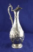 A Victorian silver claret jug, of pear form, embossed with fruit and foliate scroll decoration, with